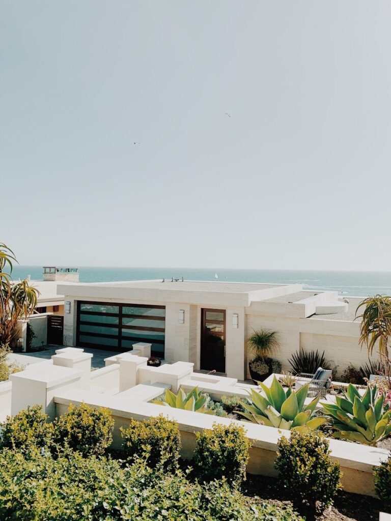 white and brown concrete building near green trees during daytime