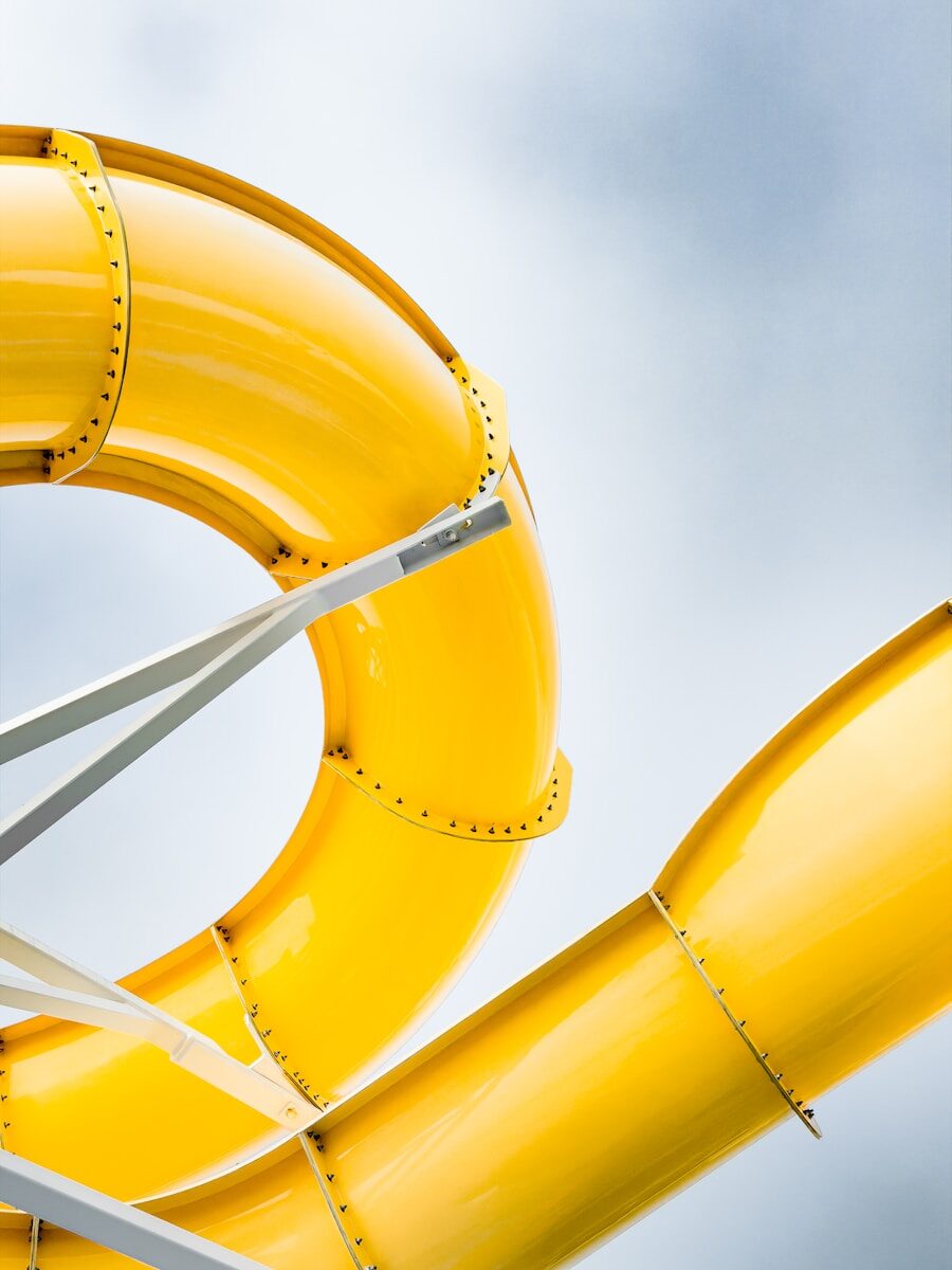 Bright yellow water slides against a cloudy sky